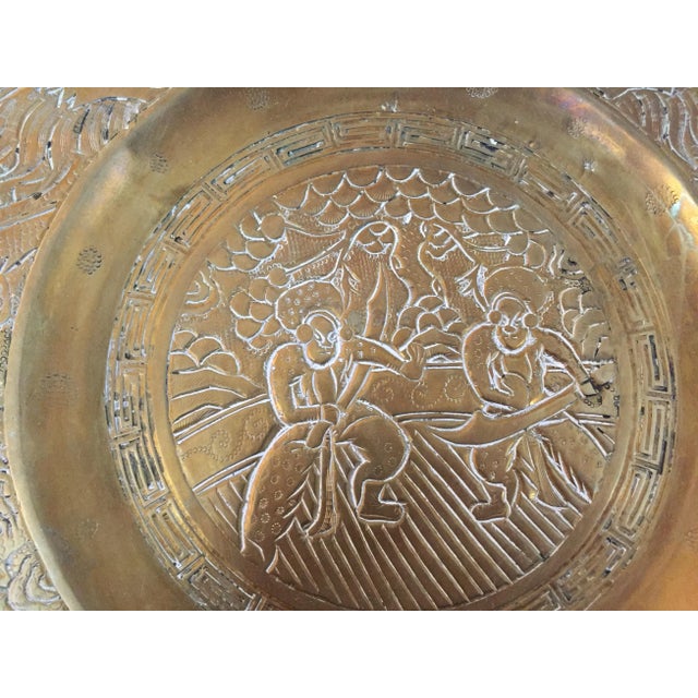 Heavy one of a kind Asian brass plate with intricate engraved detailing. Antique patina and white accents.