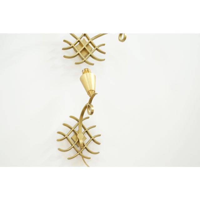Elegant set of two sculptural wall sconces attributed to Jules Leleu, comprising a one-light sconce and a two-light...