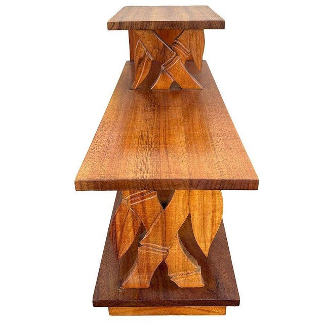 This beautifully restored 3-tiered side table is crafted from hand-carved koa wood featuring 2 front panels sculpted into...