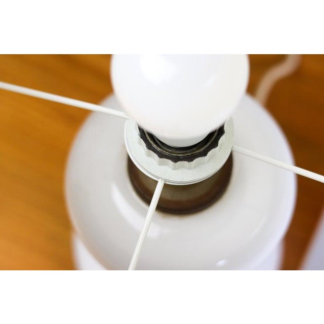 Great pair of white hand-blown glass table lamps with a white linen shade designed in 1968 by Ingo Maurer for his company...