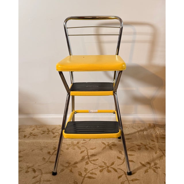 An original vintage Cosco Stylaire step stool chair in vibrant yellow vinyl with a polished chrome frame. A classic...