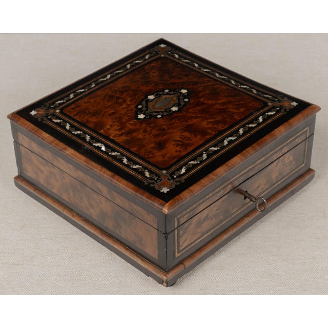 A 19th Century French Napoleon III marquetry box, hand-crafted of walnut and thuya burl wood veneers with ebonized trim....