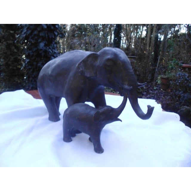 An impressive sculpture of a female elephant with calf, very decorative, with an authentic patina. The material is likely...