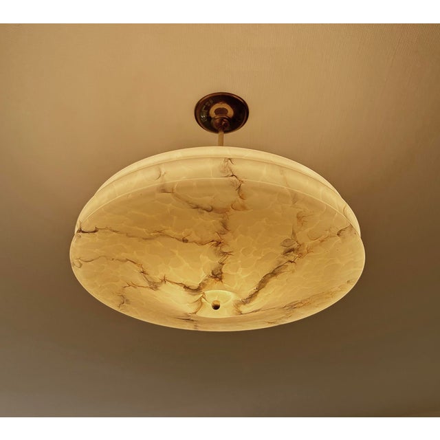 Art Deco pendant lamp from the 1930s, mottled ivory / light amber marble glass shade with indigo white veins, brass...