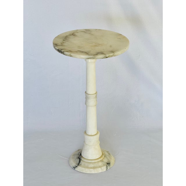 A round alabaster stand with column base. Retains original tag. Italian from the 50’s.