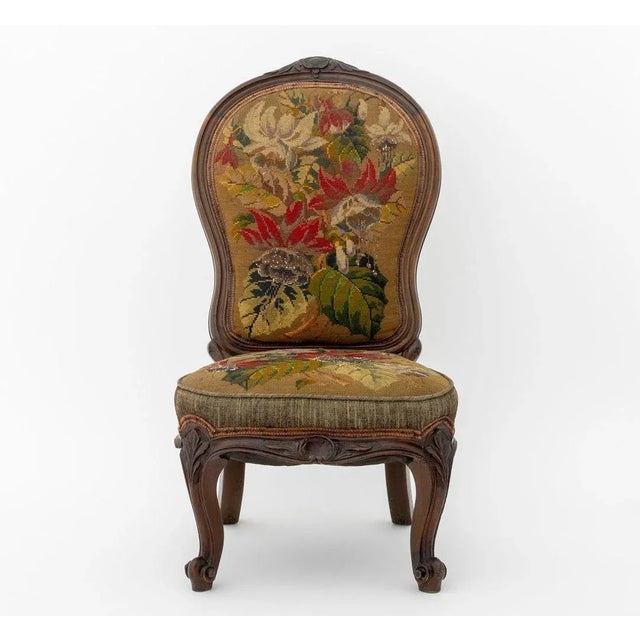 Victorian Rosewood Nursing Chair, 19th century, with floral needlepoint upholstery on four scroll form feet. 30.5" H x...