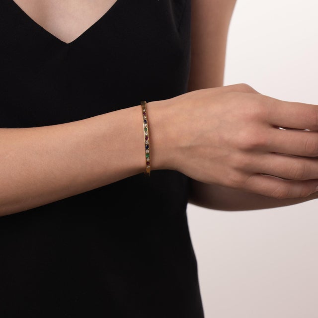 This beautiful vintage gemstone bangle is a vibrant 1970’s design, featuring 8 round brilliant cut diamonds weighing...
