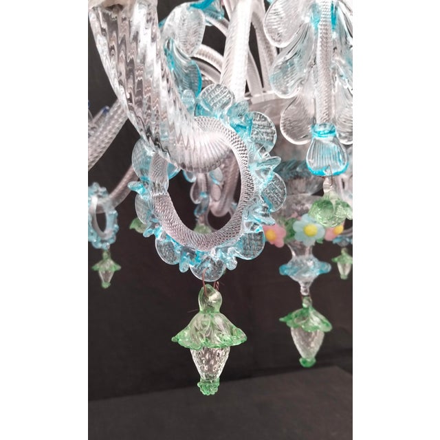 Murano glass chandelier, hand-blown and crafted by the magnificent Murano masters in clear and multicolored glass. This...