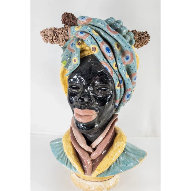 We are selling this attractive art pottery Majolica Faience style figure. This attractive black figure might be an African...