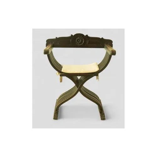 Elegant Savonarola chair in dark wood, featuring the characteristic crossed “X” structure inspired by Italian Renaissance...