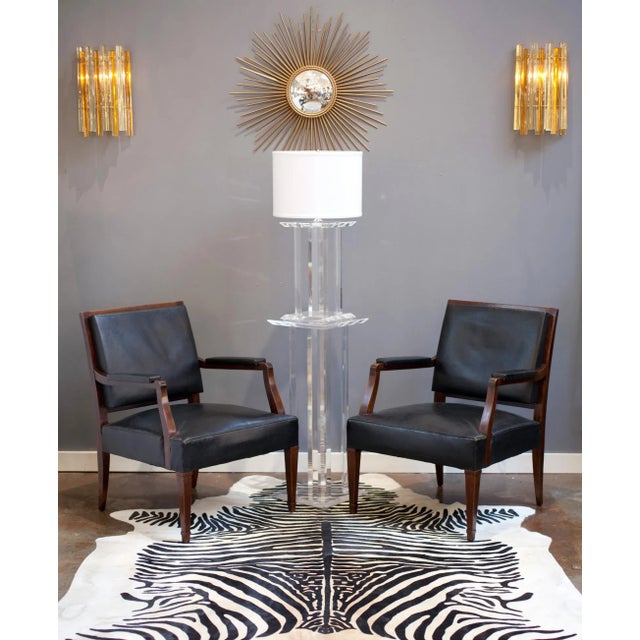 Circa 1950, French vintage pedestal and table lamp in lucite (clear acrylic). The table lamp, rewired for the US, rests...