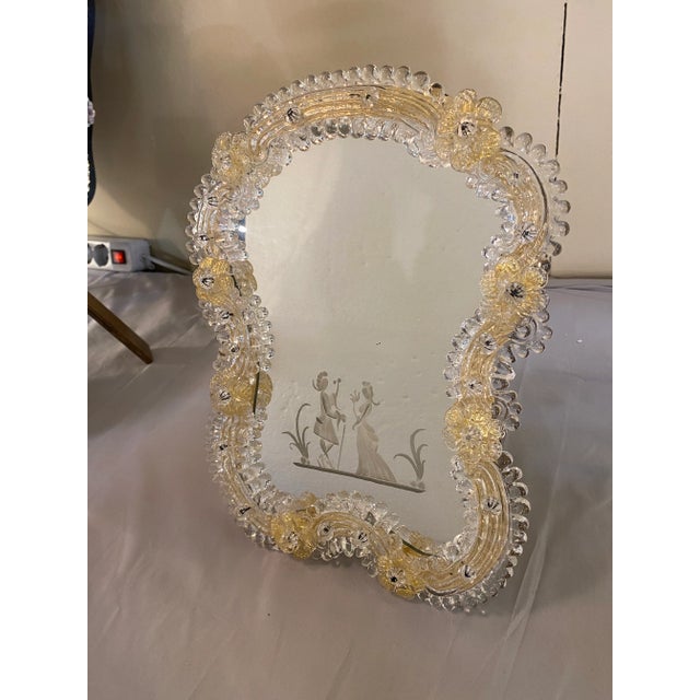 Venetian floreal table mirror in Transparent and Gold style Murano Glass with hand-made engravings. Flowers pinched by...