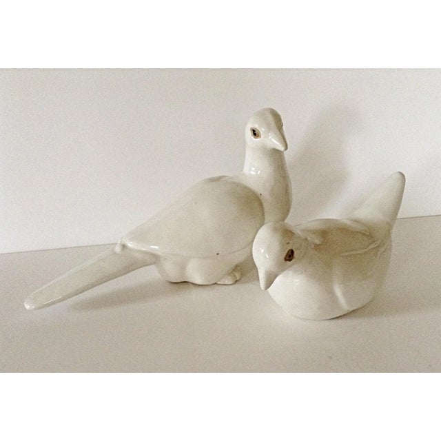 Perfect for decor at a wedding or as a gift to the new couple this pair of pottery love birds has a thick cream glaze. The...