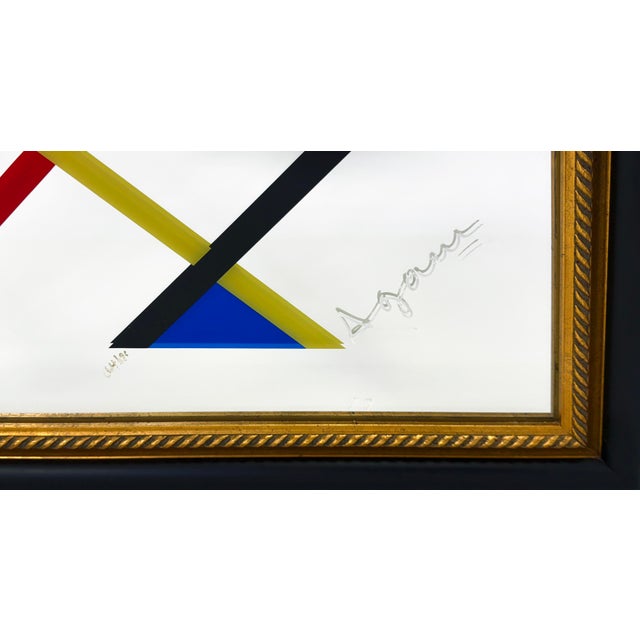 Serigraph with pigments on mirrored glass. Hand signed lower front by Yaacov Agam. Hand numbered 64/90 lower front....
