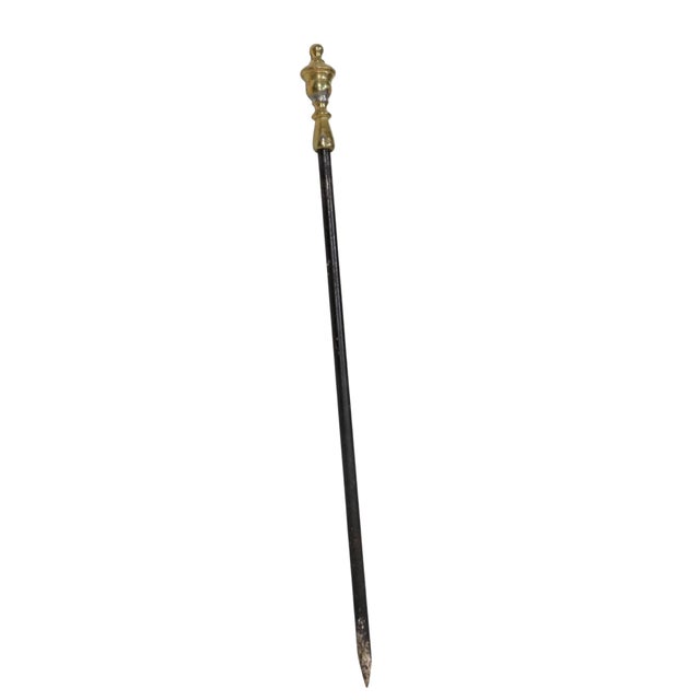 Elegant antique fireplace poker tool, having a heavy turned solid brass handle, and a substantial wrought iron shaft. The...