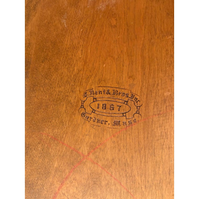 A classic set of four Cherry Brace Back Windsor style dining chairs crafted by S. Bent & Bros., Inc. of Gardner,...