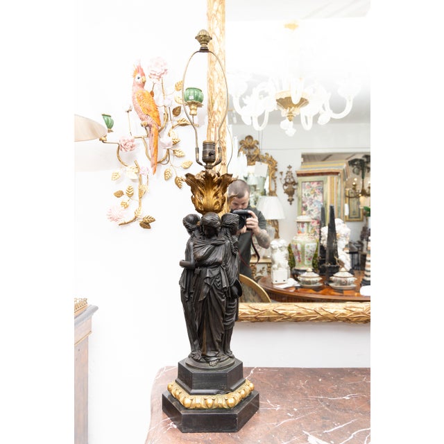 This is a stately pair of 19th century bronze figural sculptures of the Three Graces, daughters of Zeus, as lamps. Each...