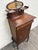 This is an elegant antique Victorian Rococo Revival music cabinet crafted in richly toned mahogany with graceful...