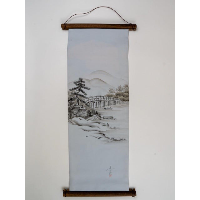A bridge over still water. Painted in ink on silk, once. The Hashi-Suiboku is a wall tapestry mounted from a length of...