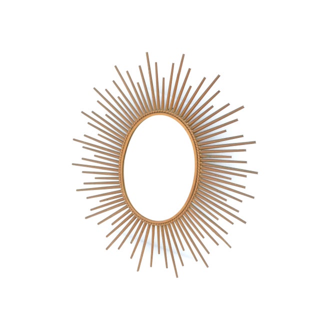 Superb French Mid-Century Modern oval metal sunburst wall mirror in gold finish. Marked on the reverse Chaty Vallauris,...