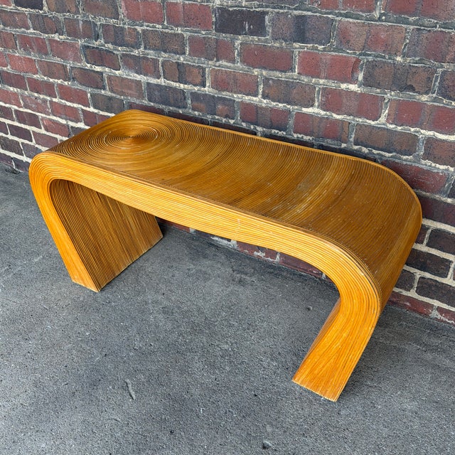 A striking Mid-Century Modern console table in the style of Gabriella Crespi, featuring an elegant waterfall form wrapped...