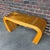 A striking Mid-Century Modern console table in the style of Gabriella Crespi, featuring an elegant waterfall form wrapped...