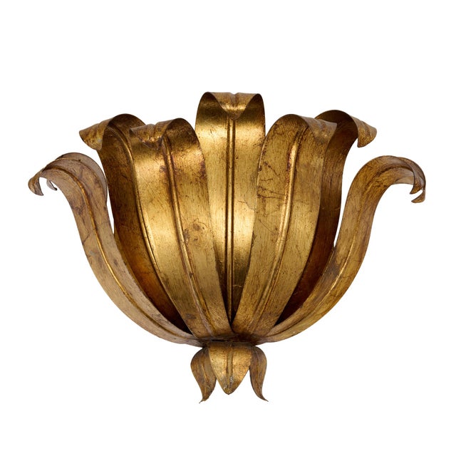 A wonderfully sculptural Italian wall sconce composed of hand-formed gilt metal leaves arranged in the form of an open...