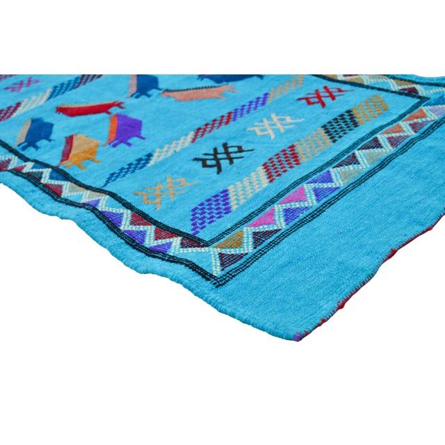 Handwoven Moroccan flat-weave wool and silk rug, featuring an elegant rhythmic pattern of colorful birds, intricate Berber...