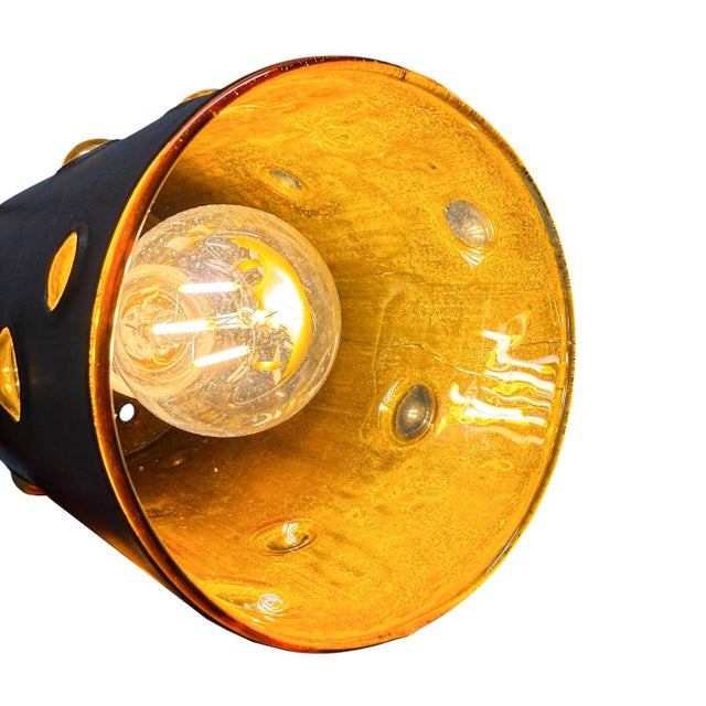 Striking Mid Century Modern pendant lamp designed by Nanny Still for Peill & Putzler, dating from the 1960s. This highly...