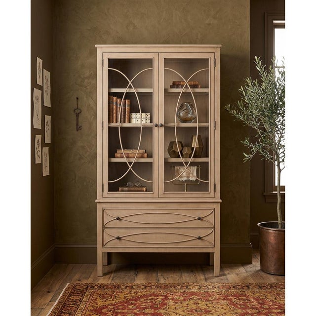 Interlaced oval fretwork spans the glazed doors from top to bottom, turning their clear panels into a decorative feature....