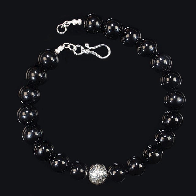 A 20‑inch strand of highly polished onyx beads already has presence, but this necklace takes it to another level. Each 20...