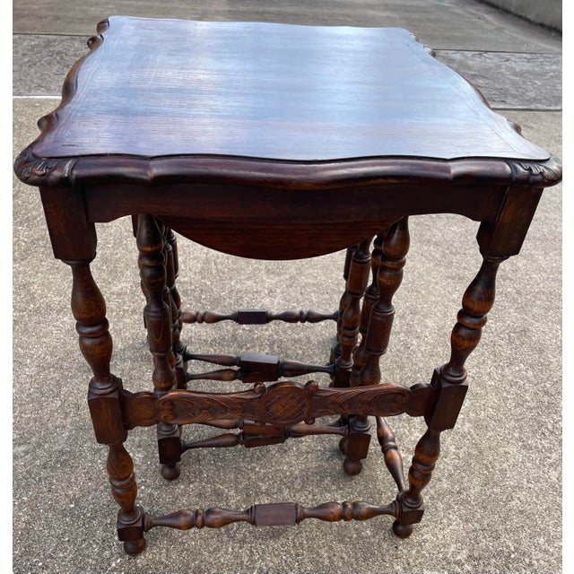 Great set of French nearing tables featuring two foldable drink tables underneath. Love the carved wood details on the sides!