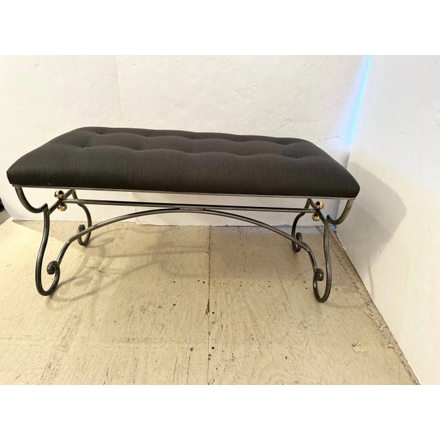 Stylish mid century modern bench having curlicue steel base with decorative brass ball accents and upholstered in a...
