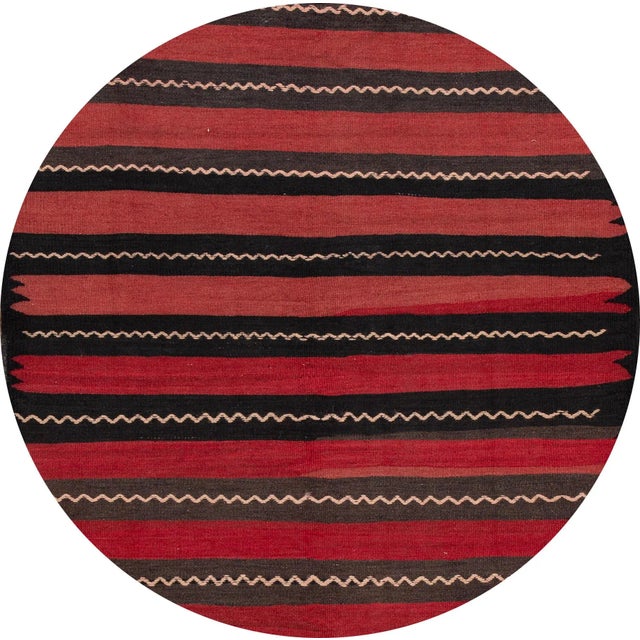 A beautiful hand-woven vintage Kilim rug with a red field and multi-color accents in an all-over stripe design. This rug...