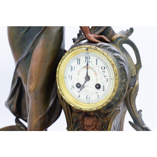 A. De raudery - 19th-20th century french school. Pendulum or living room clock with a spelter subject with a green and...