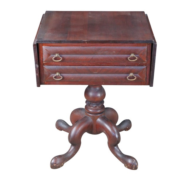 Antique American Empire mahogany sewing table or stand featuring two drawers with divided apothecary style storage...