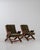 A pair of mid-20th century lounge armchairs featuring adjustable reclining backs, combining functional design with...
