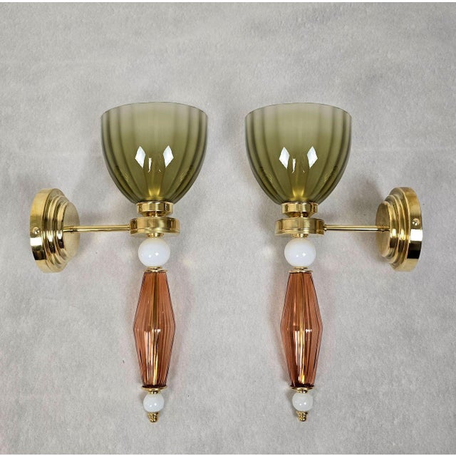 Pair of mid-century modern Murano glass wall sconces, Italy circa 1980s. The pair of Italian sconces is made of olive...