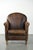 We are offering this timeless sheepskin armchair with a distinctive patina. This distinctive sheepskin armchair fits...