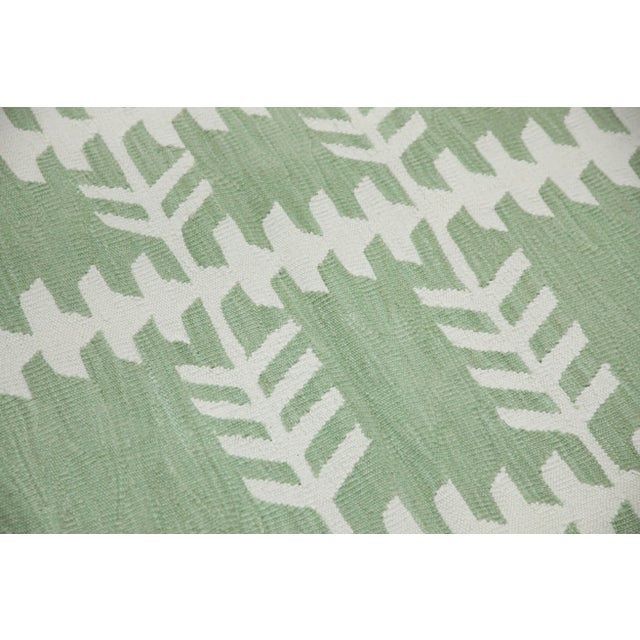 This exquisite Turkish flatweave kilim runner rug is a stunning masterpiece of traditional craftsmanship. Each rug is...