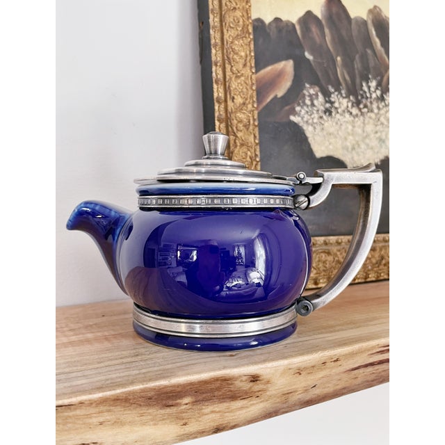 A stunning vintage circa 1929 cobalt glazed china teapot with art deco silver plated lid and frame, from the Lake Shore...