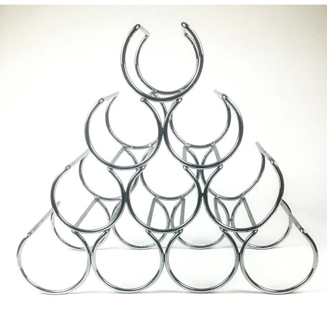 Ultra cool shaped stainless steel wine rack. Holds 10 of your favorite bottles of wine. Sits on the counter top or on the...