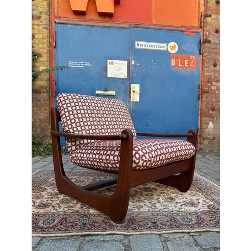 A striking statement piece from the 70s: This solid mahogany armchair combines the honest, architectural weight of...
