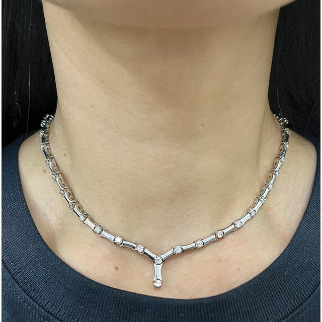 This elegant necklace showcases round white diamonds with an approximate total carat weight of 5.00. The diamonds are...