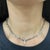 This elegant necklace showcases round white diamonds with an approximate total carat weight of 5.00. The diamonds are...