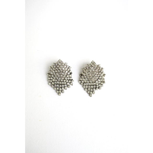This is part of Chairish’s Costume Jewelry assortment. A beautiful pair of vintage faux diamond rhinestone earrings, circa...