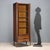 Hinged-door display cabinet with adjustable internal shelves and double open drawer. Exotic wood veneer. This piece is...