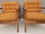 Elegant pair of Scandinavian Modern lounge chairs crafted in solid teak, dating from the 1970s. The chairs feature...