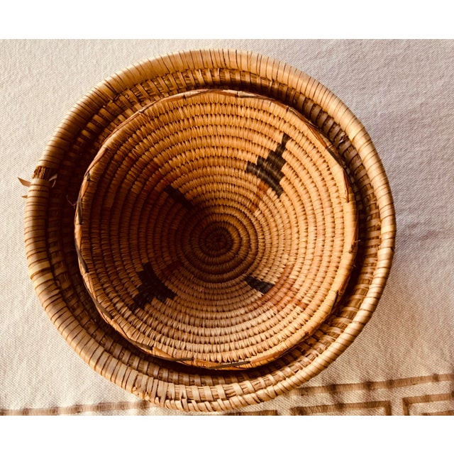 Exceptional handcrafted functionality meets timeless beauty This gorgeous pair of West African sweet grass coil baskets...