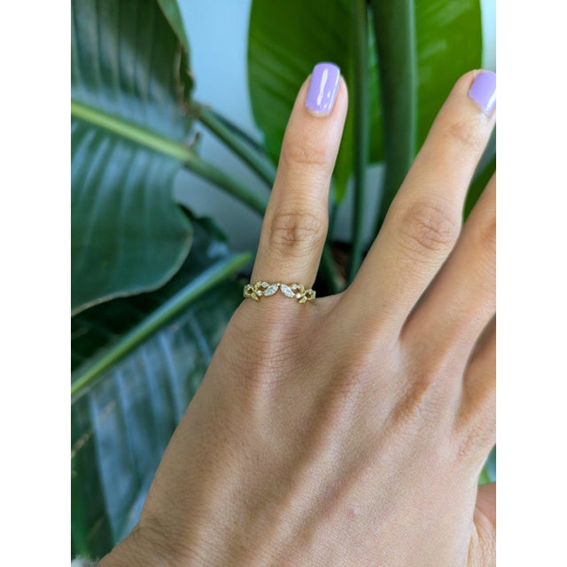 Ten earth-mined diamonds sparkle across this solid 14K yellow gold band. A classic, versatile design that shines on its...